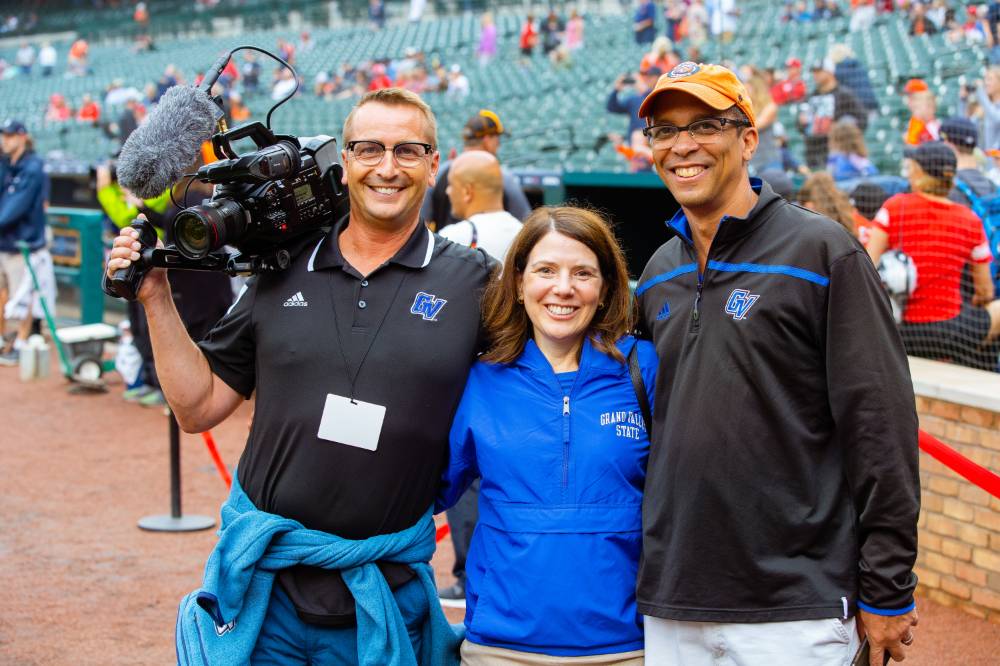 Two people at Comerica Park with a camera man